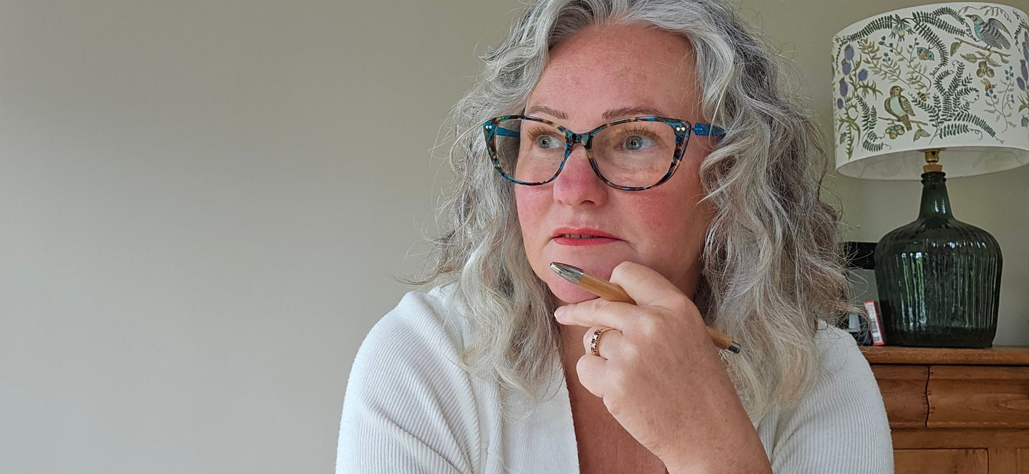 Sarah Petrie, pen in hand, deep in thought